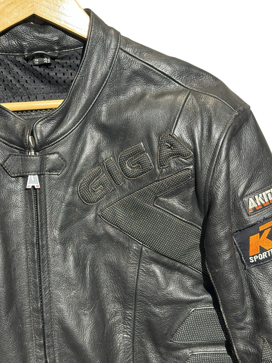 OutOf10 AKITO black leather motorcycle jacket with textured panels, front zipper, and sport-inspired branding.