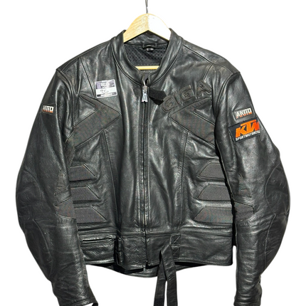 OutOf10 black AKITO leather motorcycle jacket with KTM branding, textured panels, and adjustable waist straps.