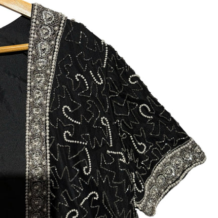 OutOf10 black open-front cardigan jacket with intricate silver and white hand-beaded patterns and ornate border trim.
