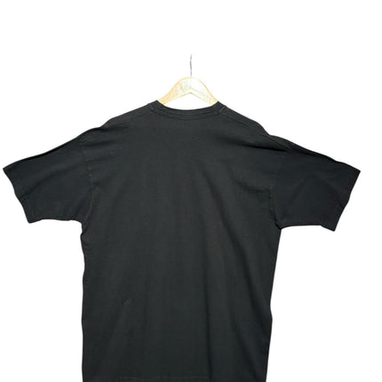 OutOf10 black crew-neck cotton t-shirt, back view of a plain vintage-style shirt on a wooden hanger.