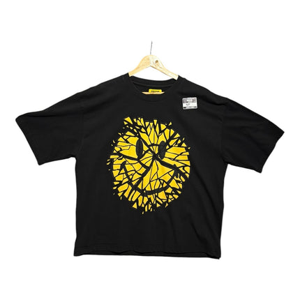 OutOf10 black cotton t-shirt featuring a vibrant yellow shattered smiley face graphic print on the front.