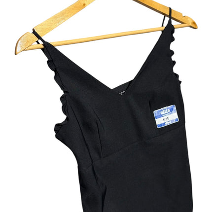 OutOf10 black sleeveless V-neck camisole with ruffled straps and a Hello name tag sticker, hanging on a wooden hanger.