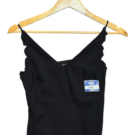 OutOf10 black sleeveless camisole with a deep V-neckline and delicate ruffled thin straps on a wooden hanger.
