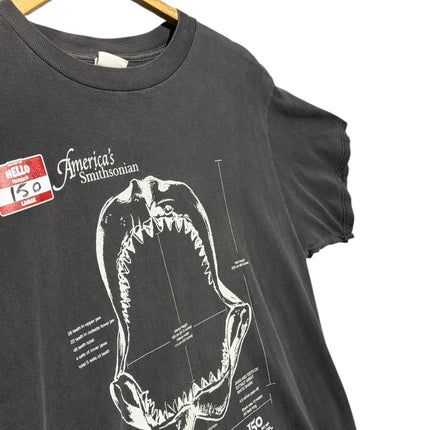 OutOf10 black cotton t-shirt featuring a white technical shark jaw illustration and Smithsonian anniversary graphic.