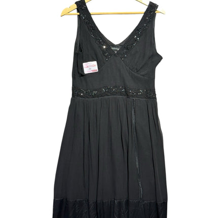 OutOf10 black sleeveless silk dress with V-neckline, sequin embellishments, and a pleated skirt on a wooden hanger.