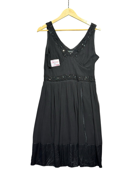OutOf10 black sleeveless silk dress with V-neckline, sequin embellishments, and a pleated skirt on a wooden hanger.