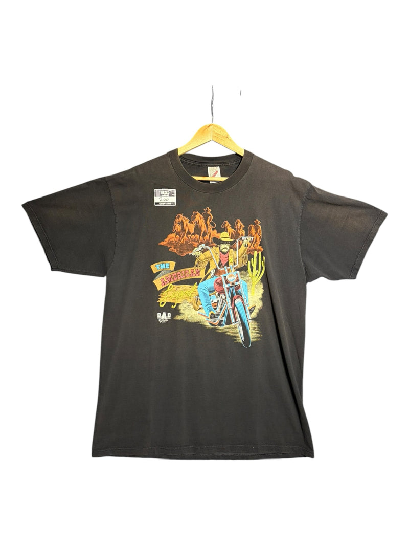 OutOf10 black cotton t-shirt featuring a vintage graphic of a cowboy riding a motorcycle in the desert
