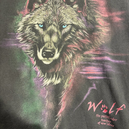 OutOf10 black cotton t-shirt featuring a vibrant wolf portrait with green, purple, and pink ethereal graphic details.