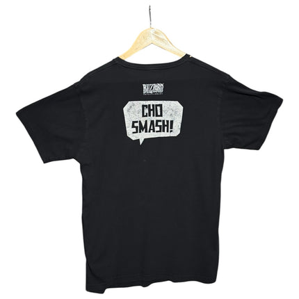 Back view of a black OutOf10 Blizzard Entertainment cotton crewneck t-shirt featuring a white Cho Smash speech bubble