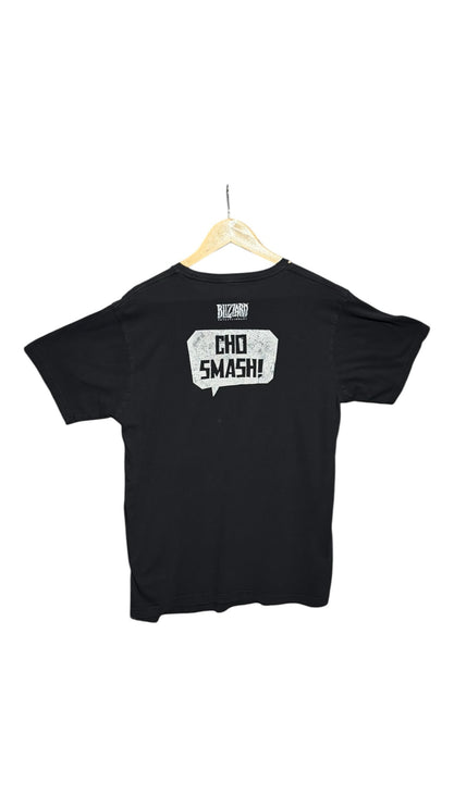 Back view of a black OutOf10 Blizzard Entertainment cotton crewneck t-shirt featuring a white Cho Smash speech bubble