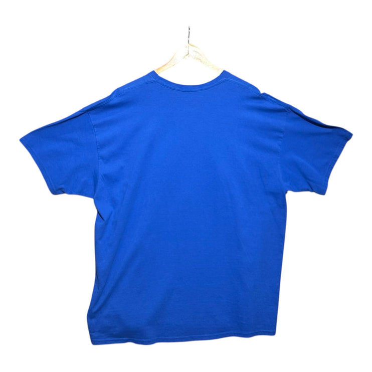 OutOf10 blue crew neck t-shirt viewed from the back, hanging on a wooden hanger against a plain white background.