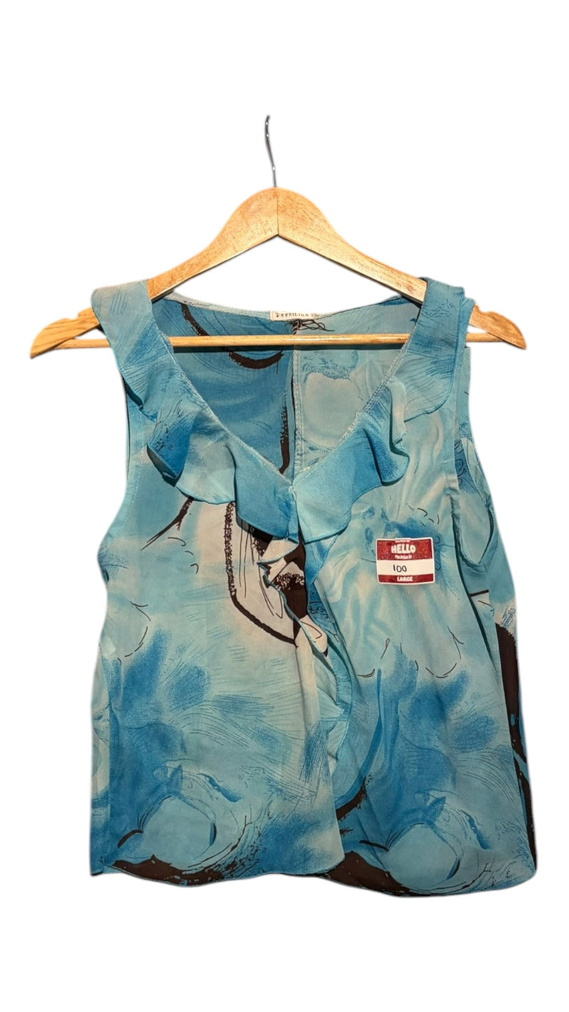 OutOf10 sleeveless blouse in blue with dark brown floral print and feminine ruffle trim neckline on a wooden hanger