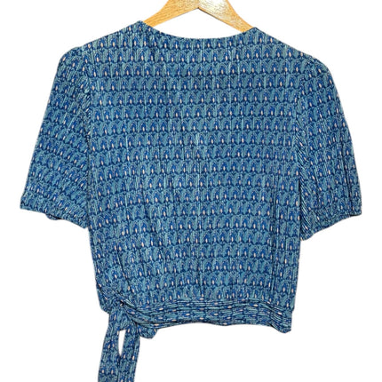 OutOf10 blue geometric print wrap blouse with short puffed sleeves and side tie detail on a wooden hanger