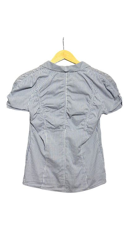 OutOf10 blue and white gingham short sleeve button-down shirt with delicate back ruching details on a wooden hanger