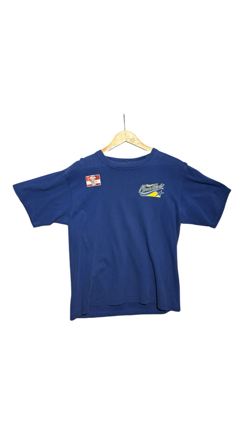 OutOf10 blue cotton t-shirt with Movie World logo on the chest, hanging on a wooden hanger against a white background.