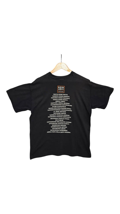 Back view of OutOf10 black cotton Bon Jovi concert tour t-shirt featuring a list of global venues and tour dates.