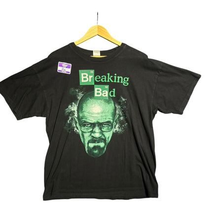OutOf10 black cotton crewneck t-shirt featuring a green Walter White Breaking Bad graphic print on a wooden hanger.