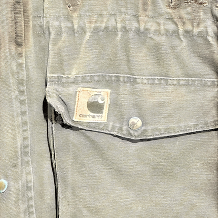 OutOf10 vintage brown Carhartt canvas field jacket with distressed texture, front pocket, and logo patch detail.