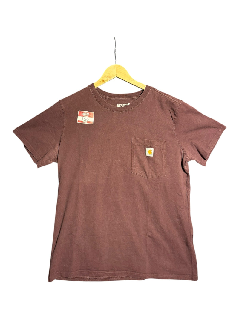 OutOf10 brown Carhartt short sleeve cotton t-shirt with a chest pocket and logo patch hanging on a wooden hanger.