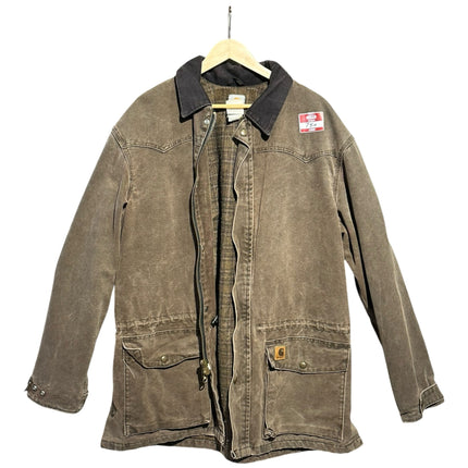 OutOf10 Carhartt brown canvas field jacket with a dark corduroy collar, front pockets, and plaid lining.