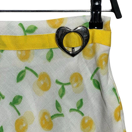 OutOf10 white A-line skirt with yellow cherry print, featuring a yellow waistband and silver heart-shaped buckle.