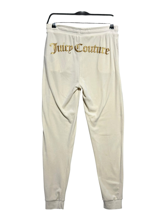 OutOf10 cream velour jogger sweatpants with gold-tone Juicy Couture logo embroidery on the back and ribbed cuffs.