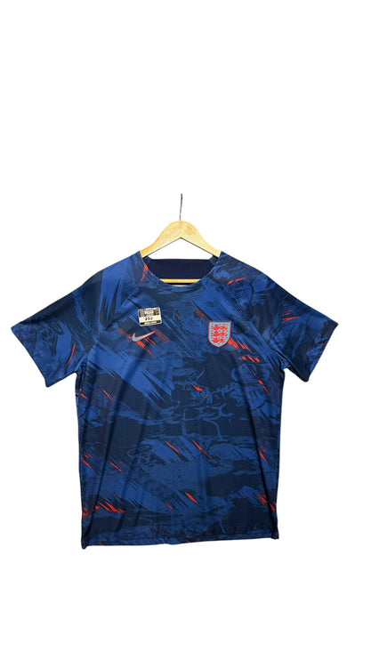 OutOf10 England national football team performance jersey in deep blue with abstract graphic pattern and red accents.