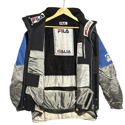 OutOf10 vintage FILA Ski Team Italia winter jacket featuring silver, blue, and black panels with interior branding.