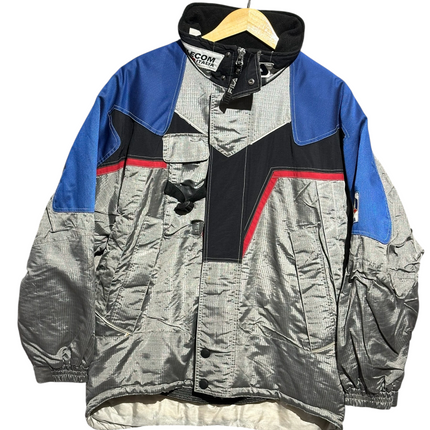 OutOf10 vintage FILA Ski Team Italia winter jacket in silver, royal blue, and black with red accents and high collar.