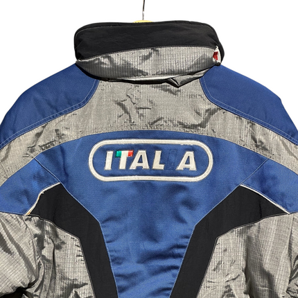 OutOf10 vintage FILA Ski Team Italia jacket in silver, blue, and black with back branding and high collar design.