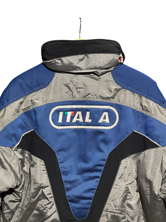 OutOf10 vintage FILA Ski Team Italia jacket in silver, blue, and black with back branding and high collar design.