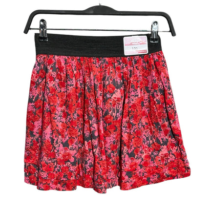 OutOf10 red and pink floral print mini skater skirt with a wide black elastic waistband hanging on a hanger