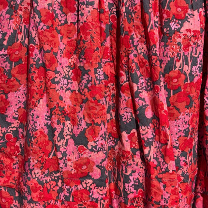 OutOf10 mini skirt featuring a vibrant red and pink floral print on a dark background with a flowy gathered design.
