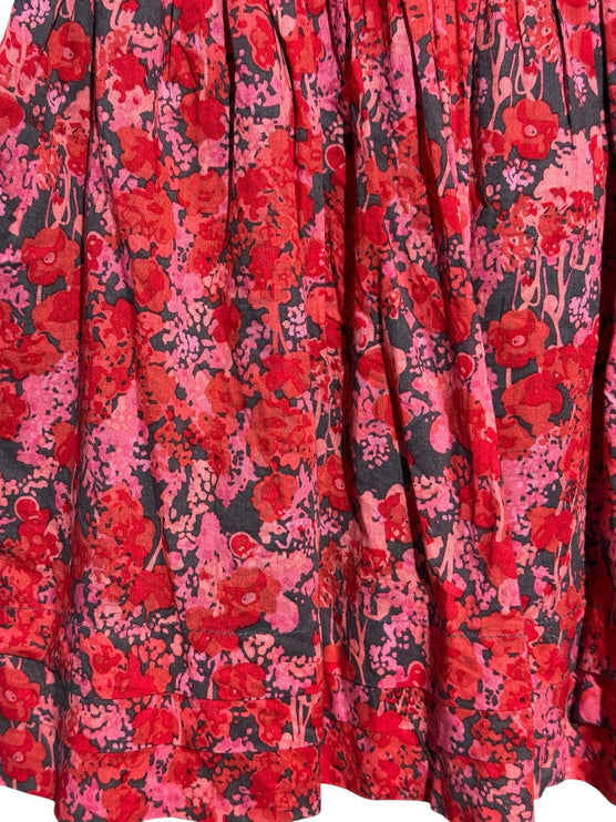 OutOf10 mini skirt featuring a vibrant red and pink floral print on a dark background with a flowy gathered design.