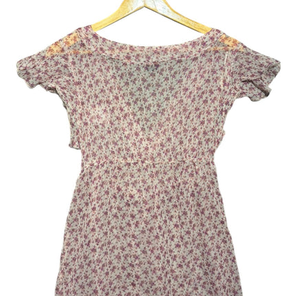 OutOf10 floral print wrap blouse in purple and white with short flutter sleeves and lightweight semi-sheer fabric.