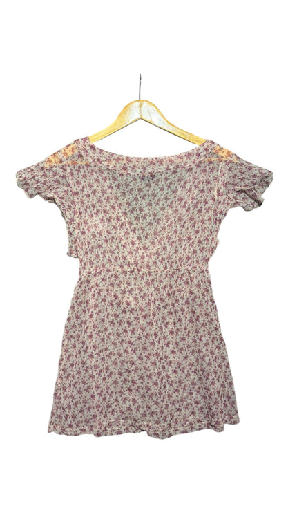 OutOf10 floral print wrap blouse in purple and white with short flutter sleeves and lightweight semi-sheer fabric.