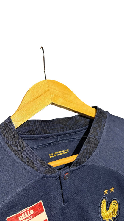 OutOf10 navy France national football jersey with gold FFF crest, two stars, and button-up collar on wooden hanger.