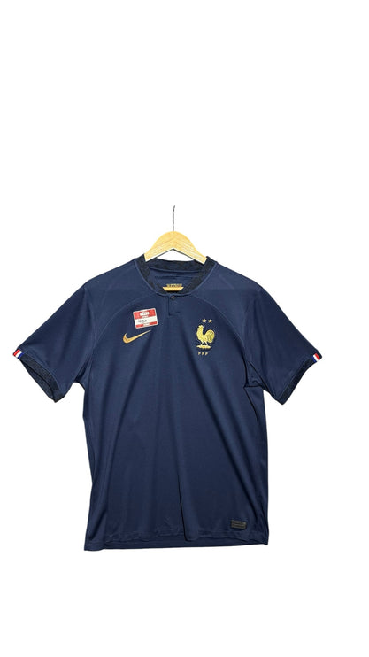OutOf10 navy France national football team jersey with gold Nike logo, FFF rooster crest, and tricolour sleeve trim.