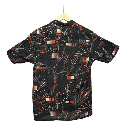 OutOf10 short sleeve button down shirt in black with a burnt orange, grey, and white geometric abstract line print.