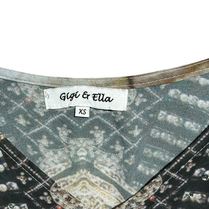 OutOf10 Gigi & Ella sleeveless printed romper featuring a V-neckline with delicate stud embellishments on earth tones.