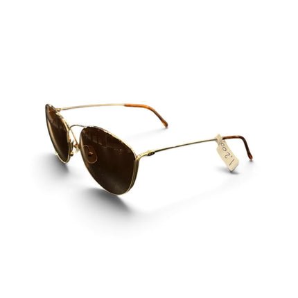 OutOf10 oversized sunglasses with gold metal frames, brown tinted lenses, and a unique cross-bridge detail.