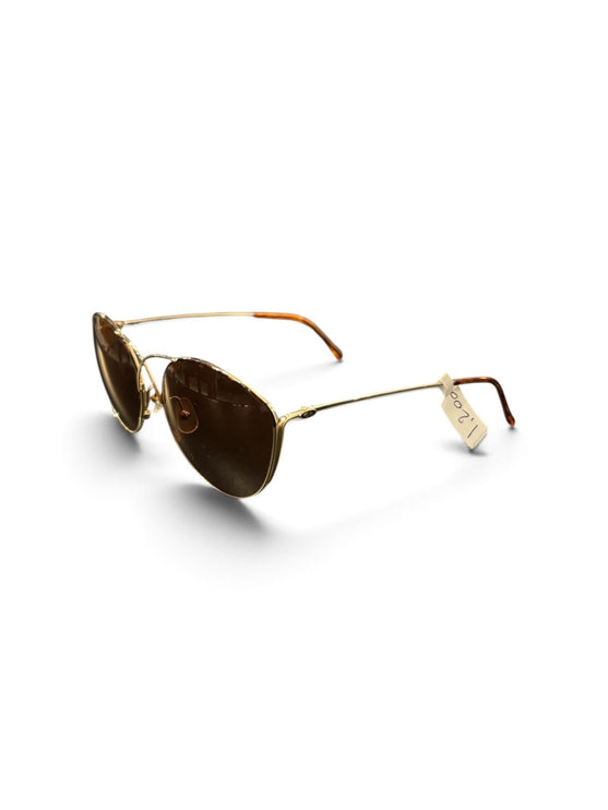 OutOf10 oversized sunglasses with gold metal frames, brown tinted lenses, and a unique cross-bridge detail.