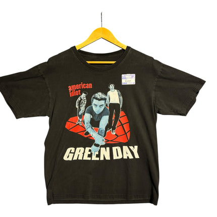 OutOf10 black cotton Green Day American Idiot graphic t-shirt with red geometric design hanging on a yellow hanger