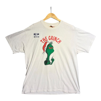 OutOf10 off-white cotton t-shirt featuring a vibrant Grinch graphic print with a Santa hat on a wooden hanger