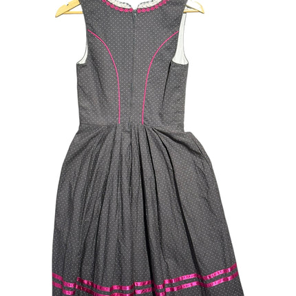 Back view of OutOf10 Hammerschmid charcoal grey dirndl dress with white polka dots, pink piping, and ribbon hem detail.