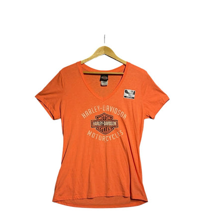 OutOf10 women's orange Harley-Davidson V-neck t-shirt with front logo graphic on a wooden hanger