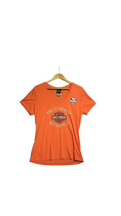 OutOf10 women's orange Harley-Davidson V-neck t-shirt with front logo graphic on a wooden hanger