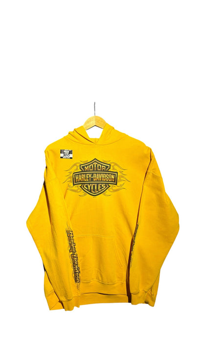 OutOf10 yellow Harley-Davidson pullover hoodie with front flame logo and sleeve text on a wooden hanger