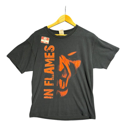 OutOf10 black cotton In Flames band t-shirt with a distressed orange vertical graphic print on a wooden hanger.