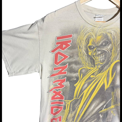 OutOf10 light grey Iron Maiden graphic t-shirt featuring Eddie mascot print and red logo on a wooden hanger